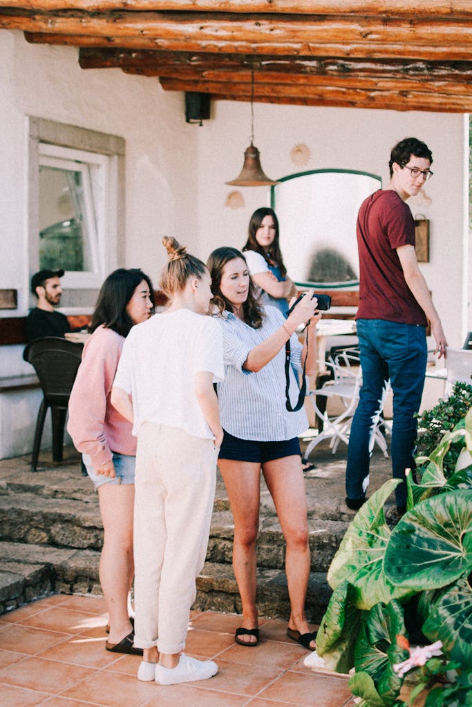 A group of young adults enjoying a casual gathering on an outdoor patio.