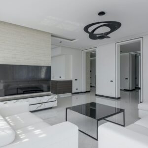 Bright and contemporary living room with sleek white furniture and modern decor.
