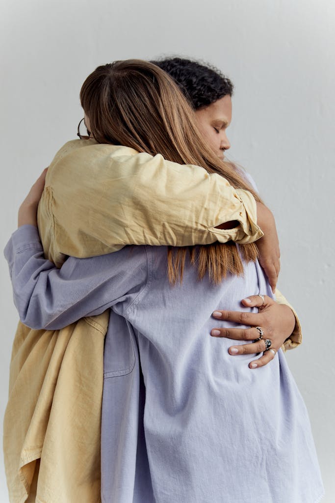 Two women embracing in a loving hug, expressing closeness and affection.